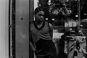 boy with sleeveless tshirt shoes in window